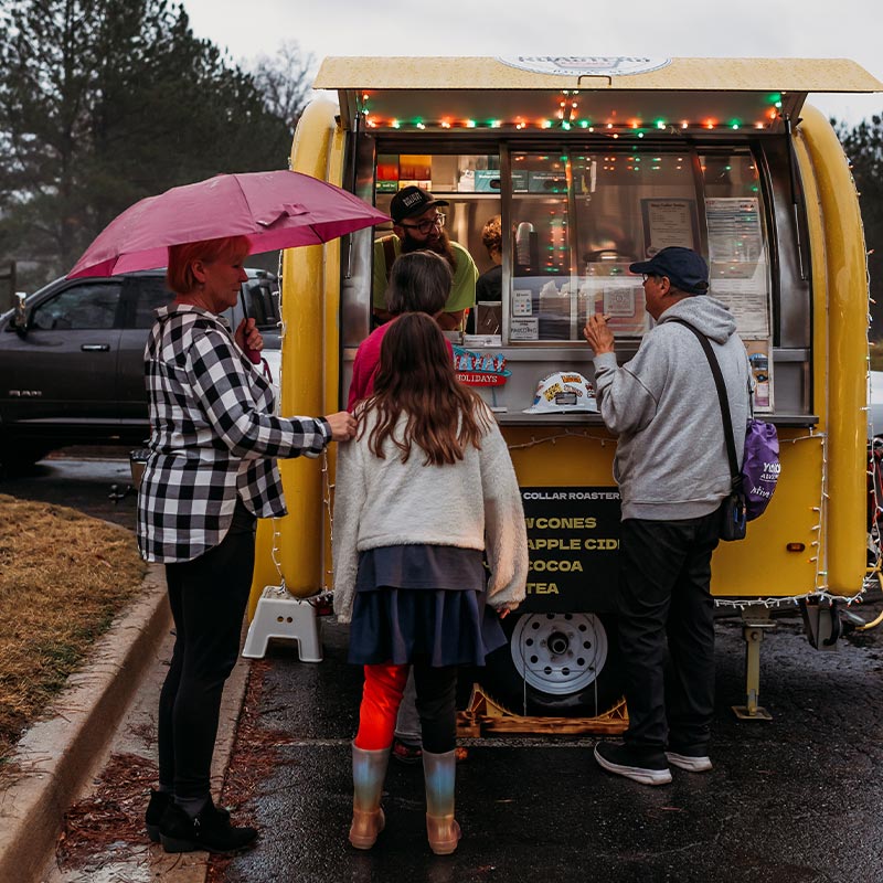 Staff Members Ordering Food At Ribbon Cutting Ceremony